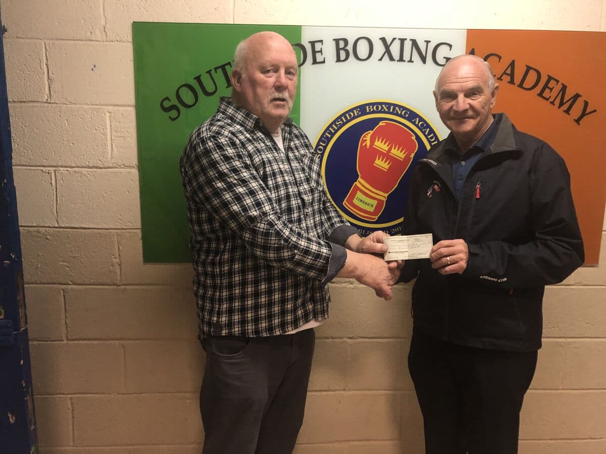 Check presentation in front of the Southside Boxing Academy sign in Limerick